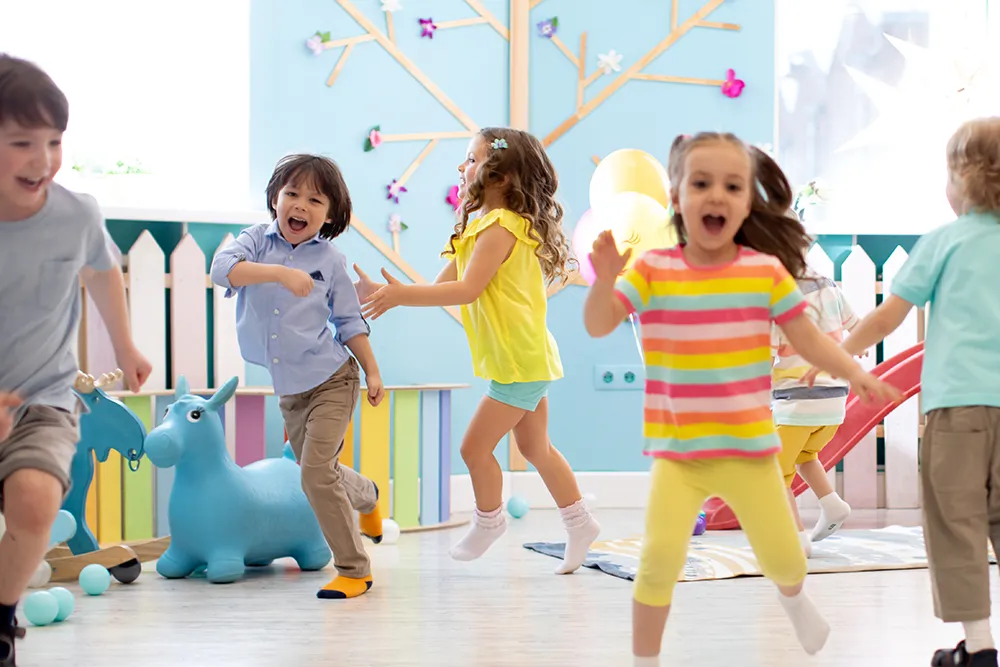 Group of happy children of boys and girls run in day care