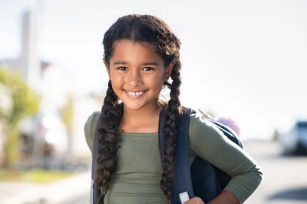 young girl wearing school backpack